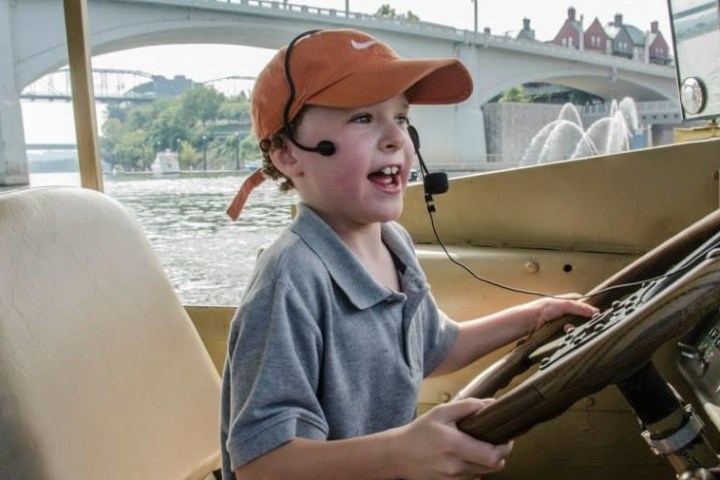 a child driving a duck boat