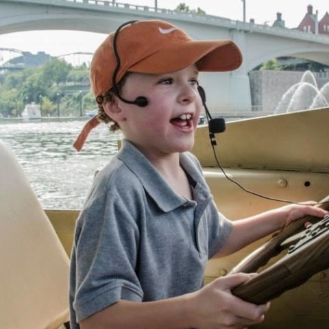 a child driving a duck boat