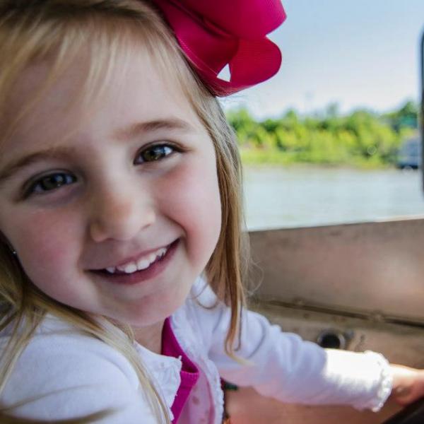 a girl driving a duck boat